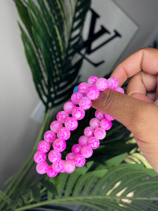 Pink beaded bracelet with marbled, crackle design.