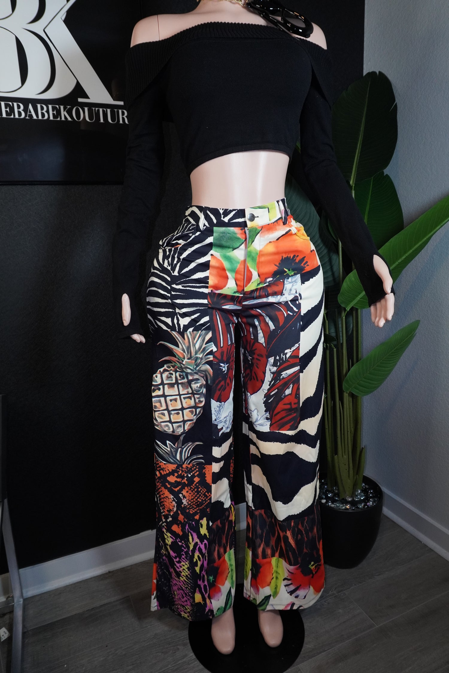Person wearing a colorful zebra print pant with a black top 