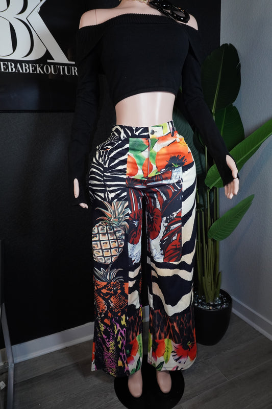 Person wearing a colorful zebra print pant with a black top 